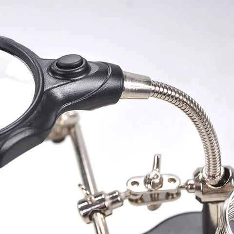 Close-up of 4X LED Magnifier Soldering Station with light, showing adjustable arm and auxiliary clips for precise DIY projects.