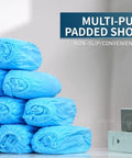 Stack of blue disposable boot and shoe covers 200 pack non slip durable for indoor and outdoor use displayed on a table.