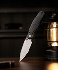 Folding Pocket Knife With A 3.34 Inch Blade And Button Liner Lock, super smooth open, hornet pro upgrade, next to a lantern.