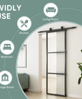 42-Inch By 84-Inch Glass Barn Door With Tempered Clear Glass, Pre-Drilled Carbon Steel Frame, installed in a living room entrance