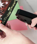 Person using Heavy-Duty Oval Hole Punch, Metal Handheld Slot Puncher for ID cards and paper on colorful paper. Precise single-hole punch tool in action.