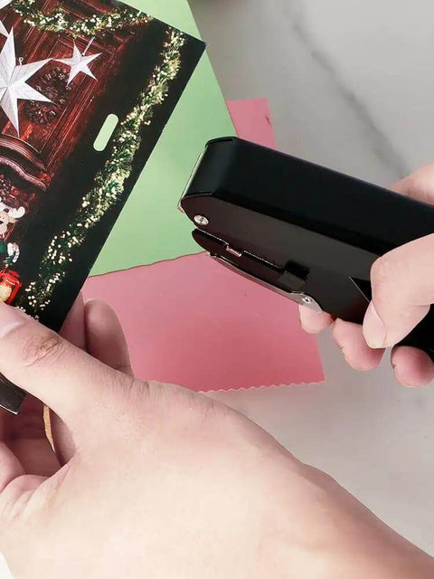 Person using Heavy-Duty Oval Hole Punch, Metal Handheld Slot Puncher for ID cards and paper on colorful paper. Precise single-hole punch tool in action.