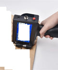 Portable Inkjet Label Printer With 12.7mm Tape Roll in use, printing text on brown paper, compact handheld design for easy handling.