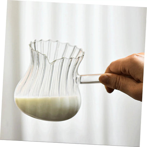 Hand holding Glass Creamer Pitcher With Spout For Turkish Coffee And Espresso, Vintage Milk Jug For Home Barista Vibes