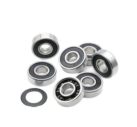 Top Tier Single Pack 6000 RS Deep Groove Ball Bearings 10mm X 26mm X 8mm Hybrid Steel Rings Ceramic Balls stacked together.