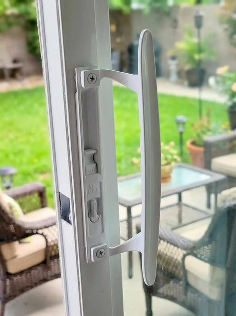 Super Slick White Diecast Sliding Patio Door Handle Set on glass door, designed for 1 to 1 1/8 inch thick panels, featuring smooth glide.