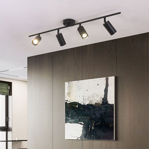 Four Light Black Track Lighting Kit With Flexible Heads Dimmable LED Indoor Ceiling Spotlight installed in modern room setting