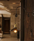 Dope Vintage Wall Sconce Featuring Classic Wrought Iron Build With Handsome Pulley Adjustment For Slick Loft Rooms And Chill Bar Decor That Seriously Slays And Looks Absolutely Lit, showcasing a movable pulley and globe shade.