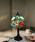 Rose Flower Tiffany Style Stained Glass Table Lamp With 8 Inch Wide Lampshade And 15 Inch Tall Red Finish on a table.
