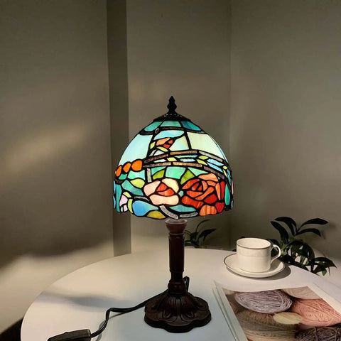 Rose Flower Tiffany Style Stained Glass Table Lamp With 8 Inch Wide Lampshade And 15 Inch Tall Red Finish on a table.