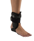 Person wearing Stirrup Ankle Brace For Stability And Support Rigid Uprights Medium Right Anatomical Footplate Comfort One Strap Closure