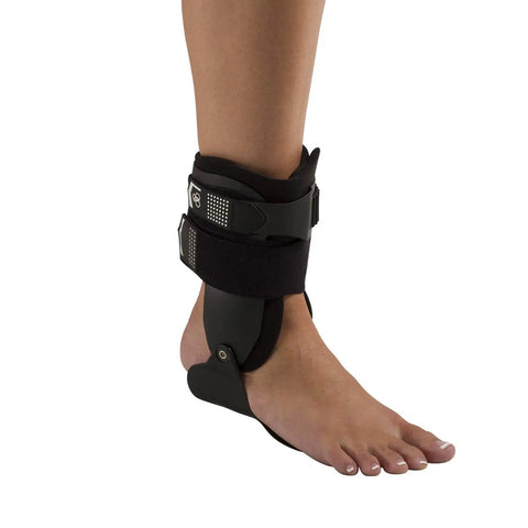 Person wearing Stirrup Ankle Brace For Stability And Support Rigid Uprights Medium Right Anatomical Footplate Comfort One Strap Closure
