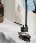 Slick Black Stainless Steel Faucet Cover Plate Three Hole Sink Escutcheon above a modern matte black faucet on a countertop.