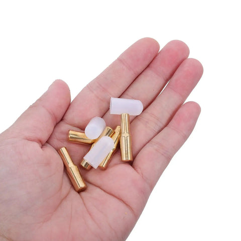 Hand holding Brass Shelf Pegs Set With Rubber Sleeves 12 Pack for wood and glass shelves flush mount support pins