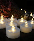 Battery Operated LED Tea Light Candles 24 Pack Flameless Flickering Warm White for Seasonal Decor displayed with flowers