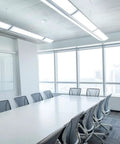Modern conference room setup with CMR 10 Contractor Select Extended Range Passive Infrared Ceiling Mount Occupancy Sensor installed