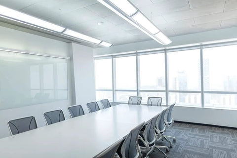 Modern conference room setup with CMR 10 Contractor Select Extended Range Passive Infrared Ceiling Mount Occupancy Sensor installed