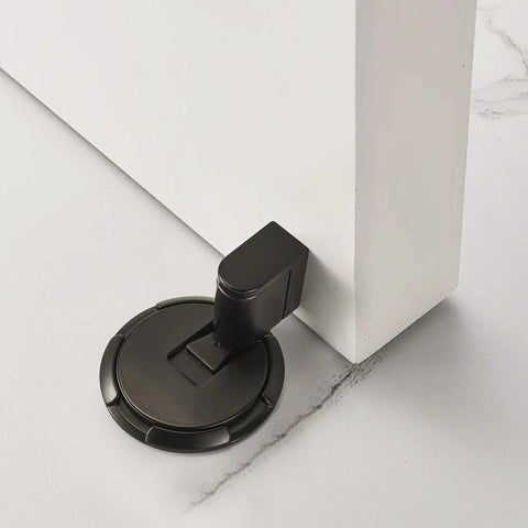 Kickass Magnetic Door Stopper Windproof Floor Hold Open Latch With Strong Adhesive Or Screw Mount For Easy No Sweat Install And Premium Heavy Duty Door Protection on a white door.