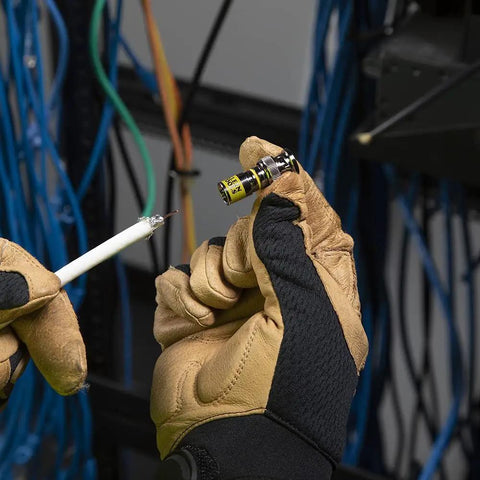 Hands holding Universal BNC Compression Coax Connector for RG6 and RG6 quad shield cables with viewing window for installation.
