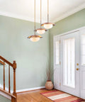 Go-To Three-Light Modern Pendant Lighting With Double Shades And White Glass Globe Inside Brushed Brass UFO Fixture in hallway