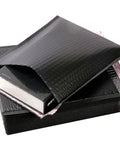 Five Pack Black Waterproof Bubble Mailers With Tear And Shake Resistant Envelope Bags For Shipping Jewelry Glass Art Photos And More Durable Protective Packaging For Mailing Supplies shown with an open flap.