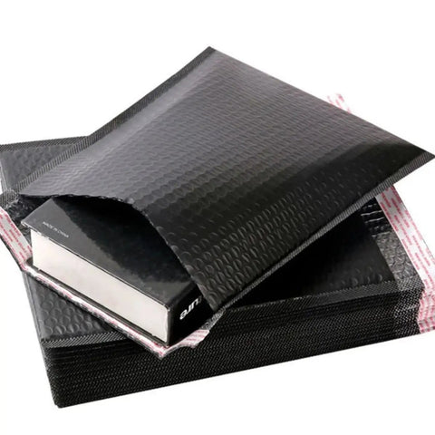 Five Pack Black Waterproof Bubble Mailers With Tear And Shake Resistant Envelope Bags For Shipping Jewelry Glass Art Photos And More Durable Protective Packaging For Mailing Supplies shown with an open flap.