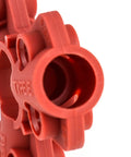Close-up of red nylon pneumatic quick-disconnect lockout kit, compatible with 1/4 to 1/2 inch connectors for industrial safety.