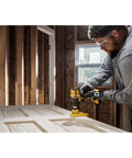Person using No Fuss Hella Slick 20V Max Brushless Cordless Drill Driver Kit With Compact Atomic Frame on a wooden door.