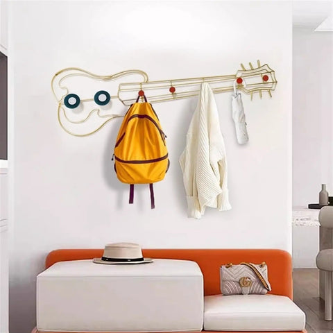 Modern Wall Mount Coat Hooks Dang Handy Entryway Storage Rack easily hangs jackets and bags on a decorative guitar-shaped rack.