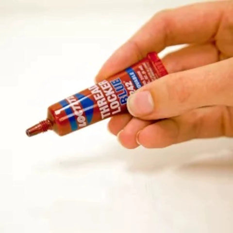 Tough As Nails Medium Strength Threadlocker Glue Secures Nuts Bolts And Fasteners Against Shake Out Vibrations Rusty Threads Removable Formula 12 Pack Of 6 Ml Tubes, held in hand, showing applicator tip.