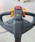 Tory 4400 Lb Electric Pallet Jack Truck With 48 By 27 Forks ergonomic handle showing push button lift and thumb wheel controls.