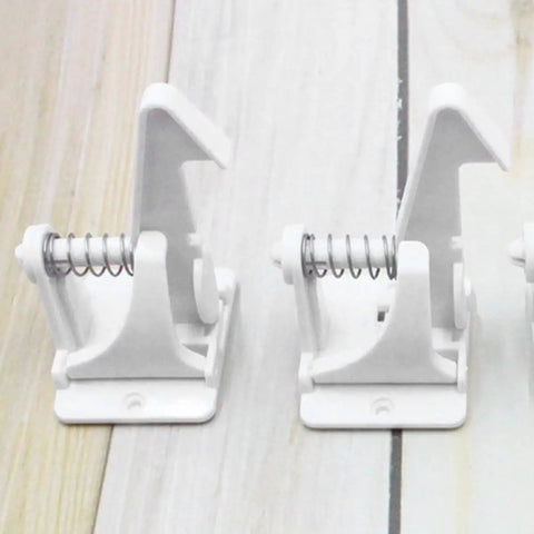 Close-up of 16 Pack Childproof Cabinet Locks For Drawers And Dressers In White ABS, Kidproof Safety Locks with spring mechanism.