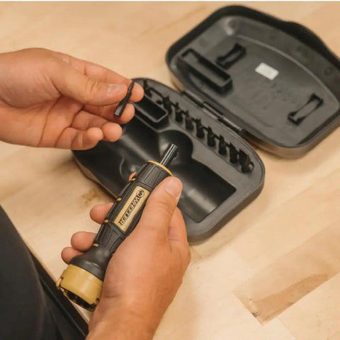 Person holding Digital FAT Firearms Accurizing Torque Wrench With Interchangeable Bits And LCD Display next to case