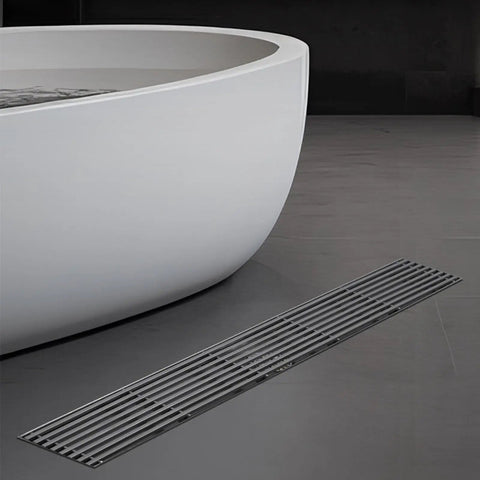 Sleek Linear Shower Drain With Locking Grate Cover For No Sweat Bathroom Floor Drainage And Anti Clog Hair Strainer Mesh Filter Effortless Cleanup Setup near a modern bathtub.