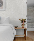 Bedroom with whimsical woodland fantasy peel and stick wallpaper in cream and white, removable for easy DIY room makeovers.