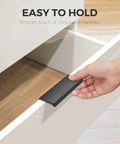 Hand holding black edge pull on drawer, 6 Pack Finger Pulls For Cabinets With 76mm Hole Center And 102mm Overall Length.