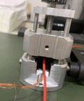 Manual Wire Stripping Tool With Hand Crank, shown stripping red copper wire, durable ABS and PC build, for copper recycling projects