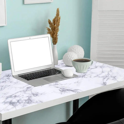 Desk covered with White Marble Peel And Stick Contact Paper Self Adhesive Wallpaper For Furniture Desks Countertops Cabinets Shelves And Walls Removable DIY Friendly Easy Clean Water Resistant 0.19mm Thick 17 Inches By 240 Inches, featuring a laptop and coffee cup.