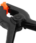 Top Tier 10 Piece Spring Clamps For Woodworking And DIY Projects With Ergonomic Handles That Grip Hard To Hold Boards Securely While You Paint Build Crafts Or Work In Your Studio Without Any Slip Ups On This Ultimate Hand Tool Kit, black plastic spring clamp close-up