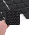 Close-up view of 48 Pack Black Rubber Feet Pads Self-Adhesive Furniture Protectors for wooden floors, 2.1 cm size, in hand.