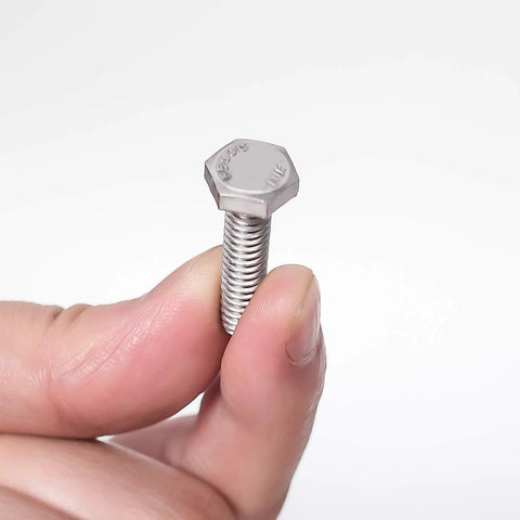 Stainless steel hex bolt, 1/4-20 x 1-1/2 in, fully threaded, held between fingers.