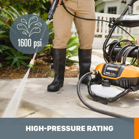 Person using 1600 PSI Electric Pressure Washer With Rolling Cart, 2240 Max PSI, 1.93 GPM on driveway, black and orange