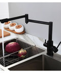 GAZOGJ Faucet, Brass Brushed Kitchen Folding Faucet with Pure Water Cold Hot Kitchen Modern Drinking Water 3 Way Filtered Faucet Mixer,Brushed with Hose-D in use above sink with vegetables.