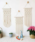Three macrame wall hangings on display, created with All In One Macrame Kit For Beginners With Natural Cotton Rope 3mm x 220 Yards A Complete Wall Hanging Set Including Wooden Beads, Rings, Sticks, S Hooks And Easy DIY Guide.