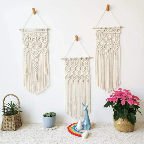 Three macrame wall hangings on display, created with All In One Macrame Kit For Beginners With Natural Cotton Rope 3mm x 220 Yards A Complete Wall Hanging Set Including Wooden Beads, Rings, Sticks, S Hooks And Easy DIY Guide.