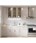 Modern kitchen with Miri Kitchen Faucet With Pull Down Sprayer And Soap Dispenser, stainless steel finish on white cabinetry.