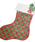 Handcrafted Christmas stocking made with red and green duct tape in a woven pattern, decorated with holly leaves and berries at the top.