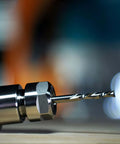 SpeTool spiral downcut router bit with 1/4 inch shank, solid carbide; close-up in metal chuck