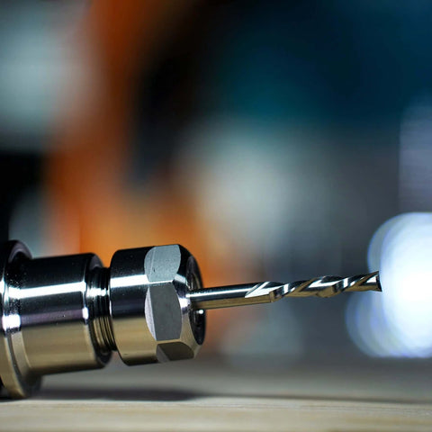 SpeTool spiral downcut router bit with 1/4 inch shank, solid carbide; close-up in metal chuck