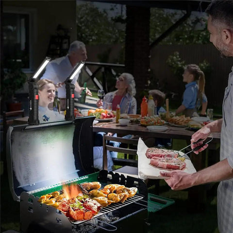 Rechargeable LED Work Light With Magnetic Base And USB Power illuminating a barbecue grill at night during a family gathering.